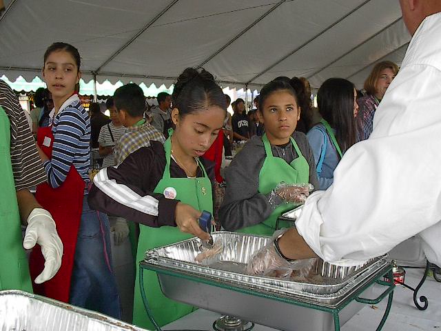 Liz and Roxy serving food.